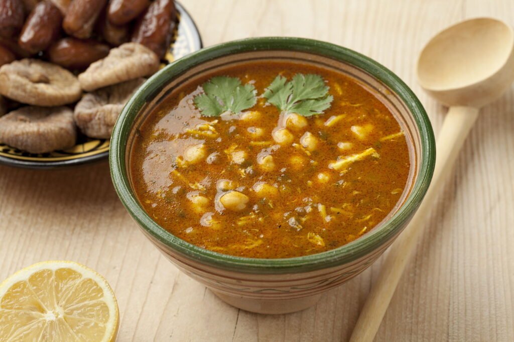 Bowl of Moroccan harira soup, lemon, dates and figs for iftar